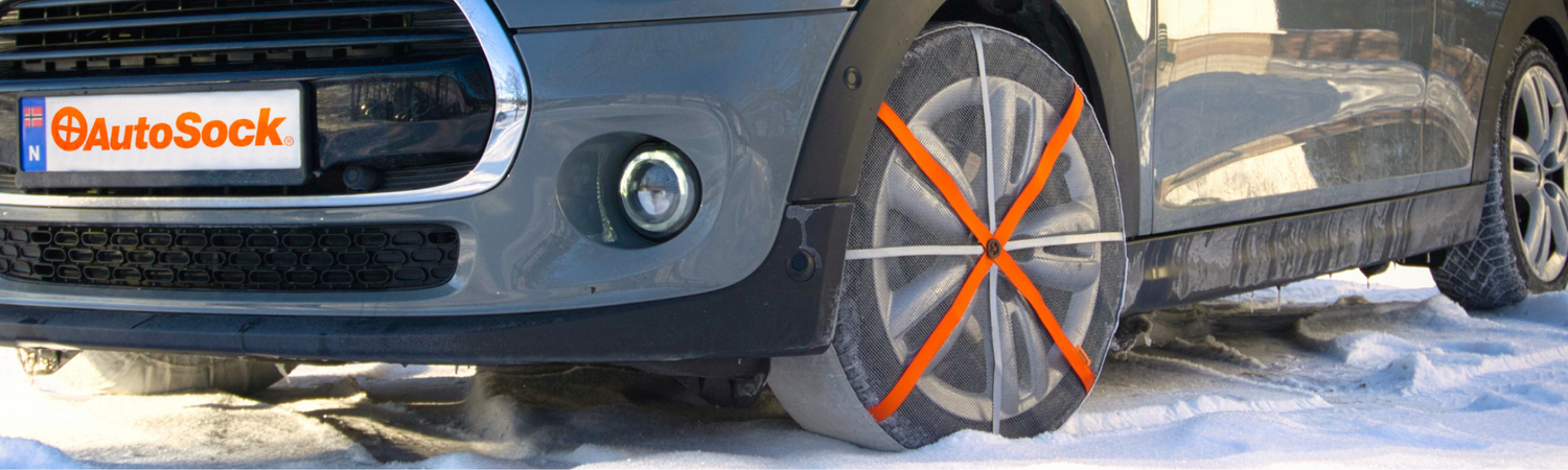 Close-up of mounted AutoSock on front wheels of a car